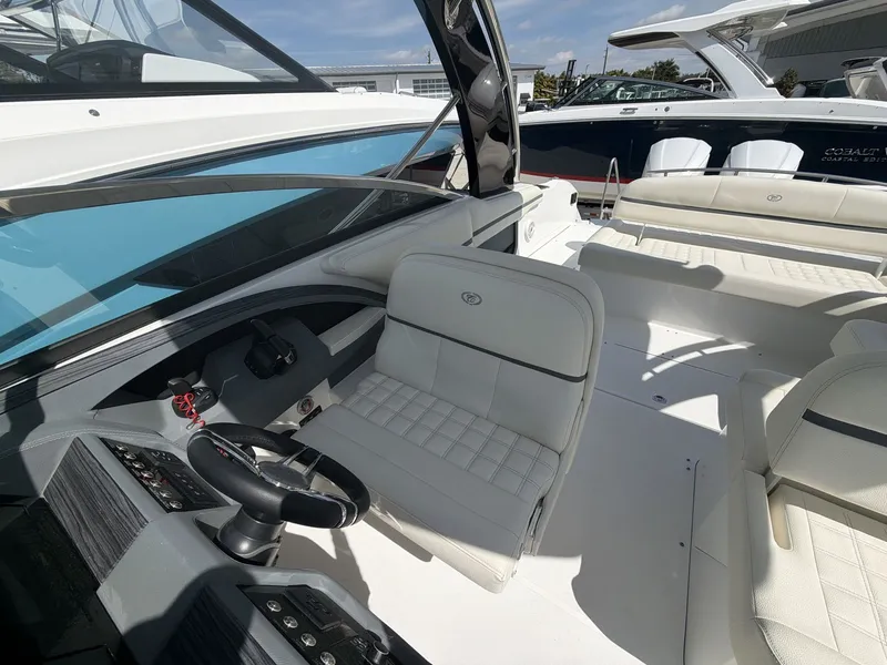 Slide: The Image of Interior of a 2021 Cobalt 30SC boat with white leather seating. - 19