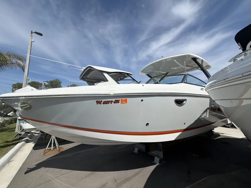 Slide: The Image of 2021 Cobalt 30SC boat on a parking lot under sunny skies. - 4