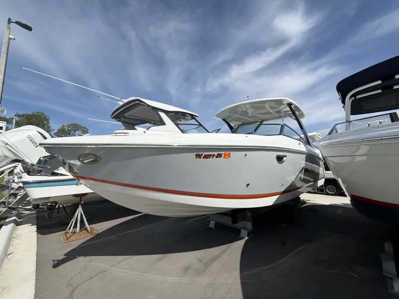 Slide: The Image of 2021 Cobalt 30SC boat displayed at a marina. - 9