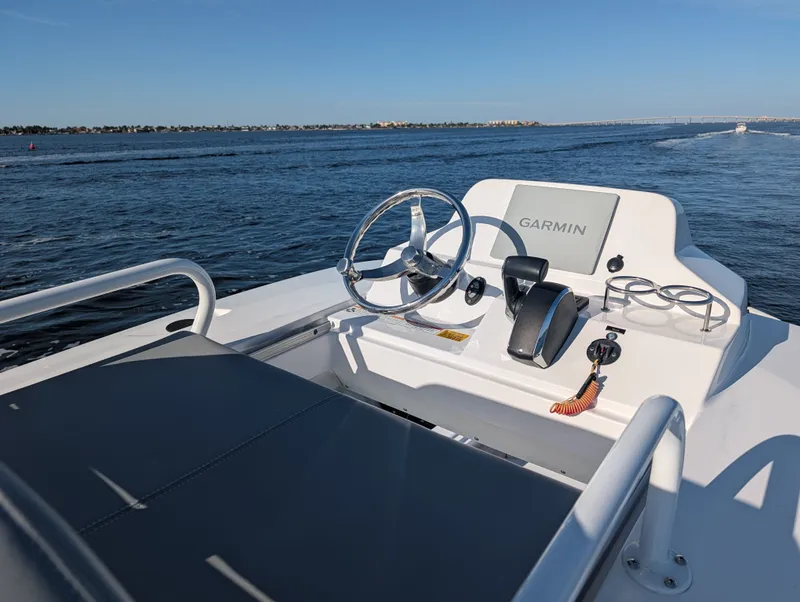 Slide: The Image of 2024 Everglades 253 Center Console boat with Garmin controls on open water. - 4