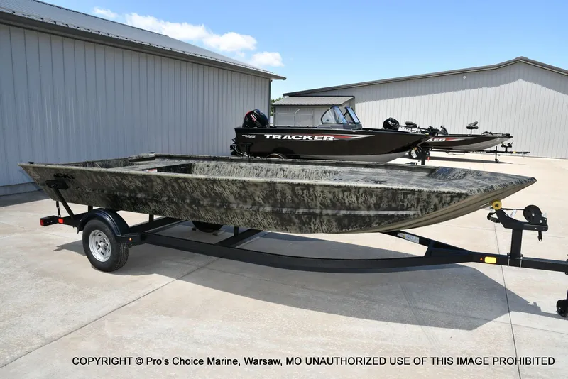 Slide: The Image of 2026 Tracker Grizzly 1860 Jon boat on trailer, outdoor setting. - 42