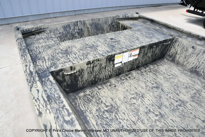 Slide: The Image of Tracker Grizzly 1860 Jon 2026 with camouflage pattern on concrete floor. - 6