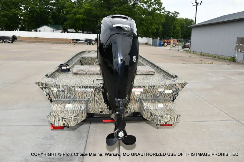 Slide: The Image of Tracker Grizzly 1860 CC 2026 with outboard motor on parking lot. - 21