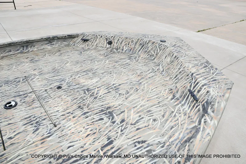 Slide: The Image of 2026 Tracker Grizzly 1860 CC with camouflage pattern on concrete surface. - 28