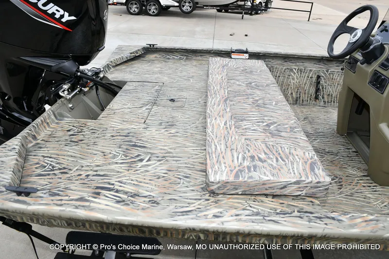 Slide: The Image of 2026 Tracker Grizzly 1860 CC boat with camouflage pattern and Mercury engine. - 29