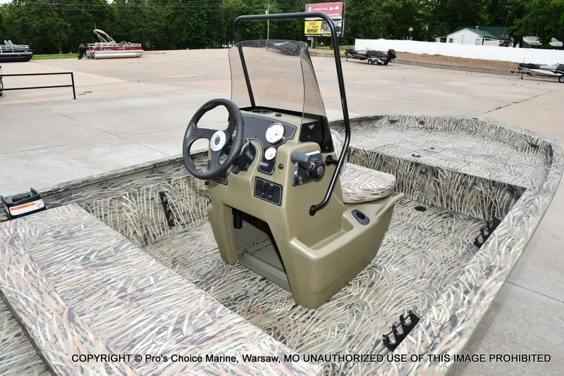 Slide: The Image of 2026 Tracker Grizzly 1860 CC boat with camouflage design outdoors. - 30