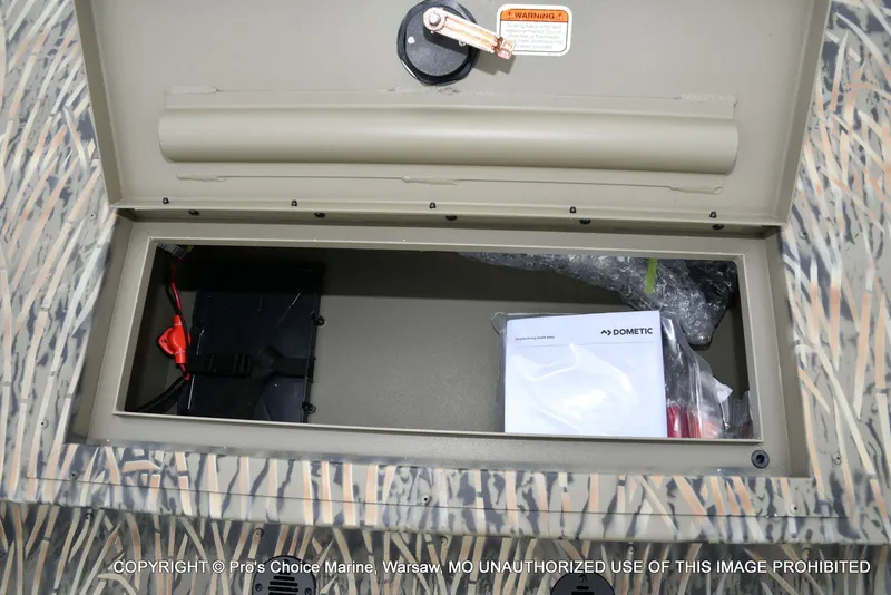 Slide: The Image of Tracker Grizzly 1860 CC 2026 storage compartment with accessories. - 43