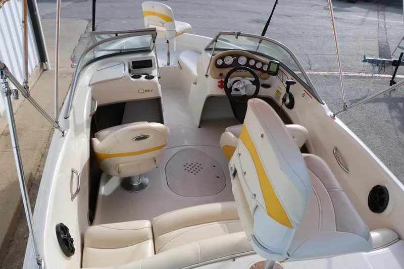 Slide: The Image of 2010 Tahoe Q5i SF boat interior with white and yellow seating, steering wheel, and dashboard. - 10