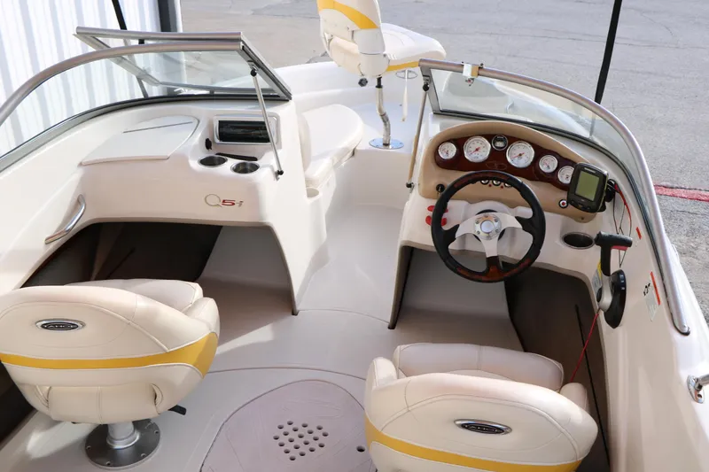 Slide: The Image of Interior of a 2010 Tahoe Q5i SF boat, featuring steering wheel and dashboard controls. - 11