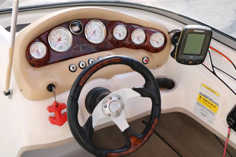 Slide: The Image of Steering console of 2010 Tahoe Q5i SF boat with gauges and GPS device. - 18