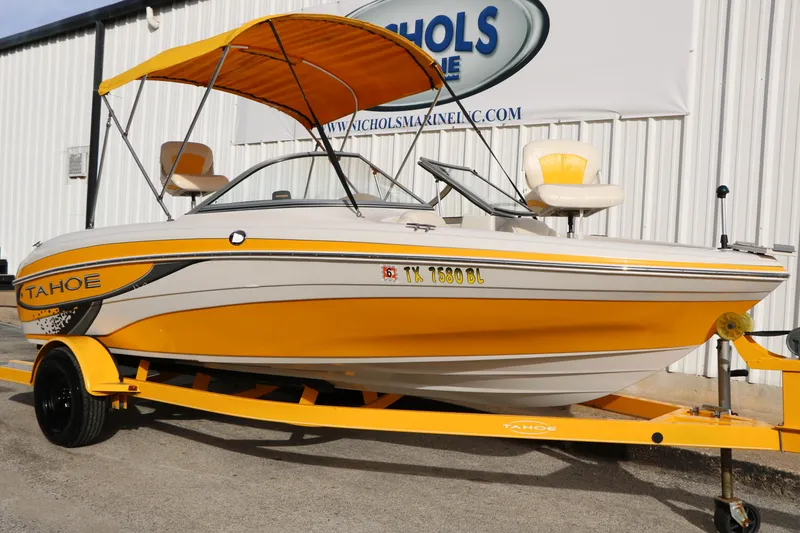 Slide: The Image of 2010 Tahoe Q5i SF boat with yellow accents and canopy on trailer. - 2