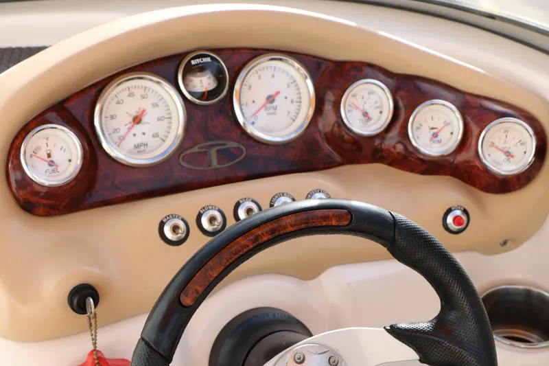 Slide: The Image of Dashboard of a 2010 Tahoe Q5i SF boat with gauges and steering wheel. - 23