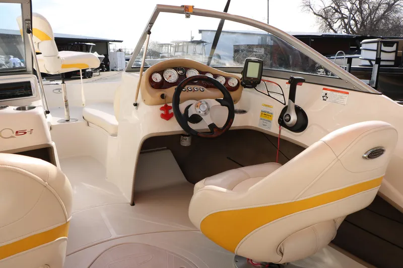 Slide: The Image of 2010 Tahoe Q5i SF boat interior with steering wheel and dashboard controls. - 24