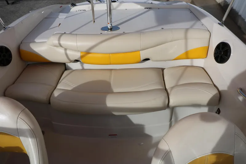 Slide: The Image of 2010 Tahoe Q5i SF boat interior with beige and yellow seating. - 27
