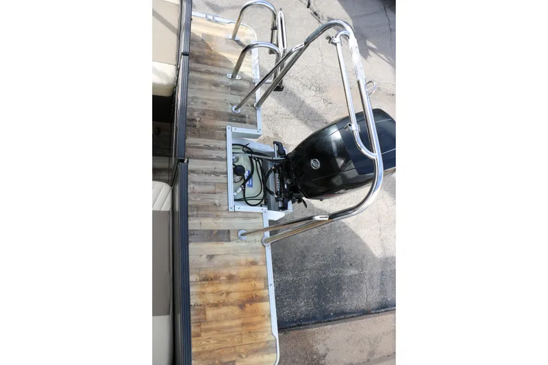 Slide: The Image of 2016 Crest II 250 boat with outboard motor and wooden deck. - 13