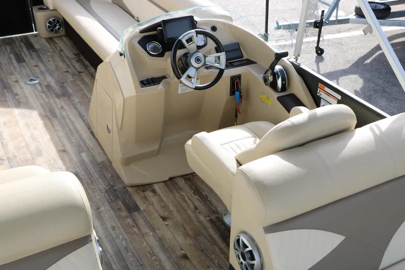 Slide: The Image of Interior of 2016 Crest II 250 boat with beige seating and wood-style flooring. - 15