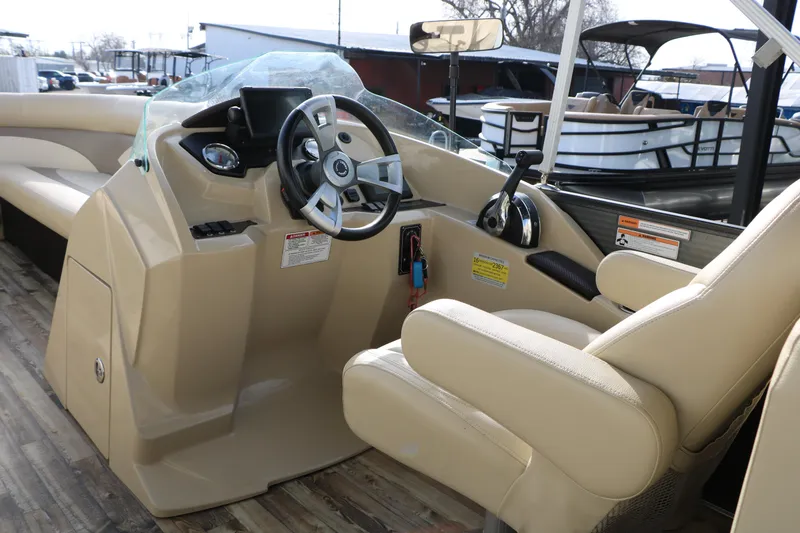 Slide: The Image of 2016 Crest II 250 boat interior with steering wheel and control panel. - 17