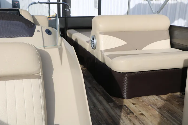 Slide: The Image of 2016 Crest II 250 boat interior with beige seating and wooden flooring. - 23