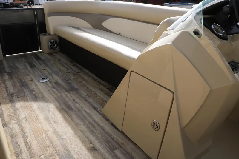 Slide: The Image of 2016 Crest II 250 boat interior with beige seating and wood-style flooring. - 24