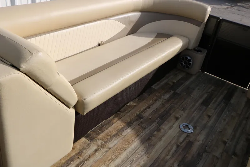 Slide: The Image of 2016 Crest II 250 boat interior with beige seating and wood-style flooring. - 25