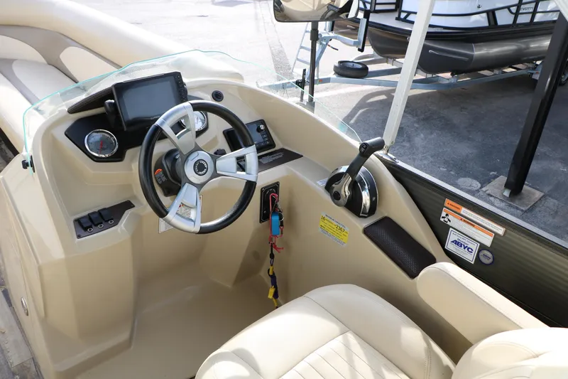 Slide: The Image of 2016 Crest II 250 boat helm with steering wheel and control panel. - 27