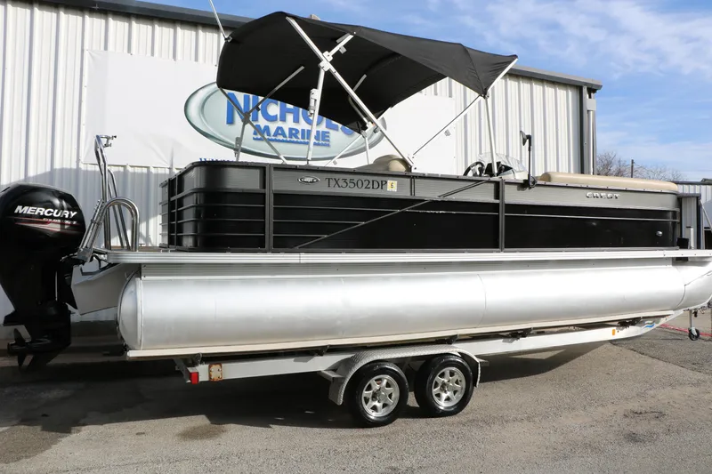 Slide: The Image of 2016 Crest II 250 pontoon boat on trailer, featuring a Mercury outboard motor. - 3