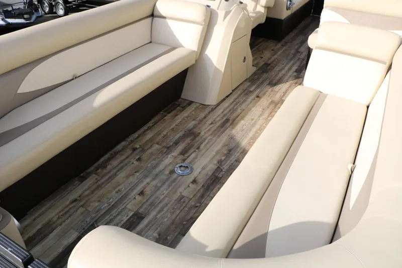 Slide: The Image of Interior of 2016 Crest II 250 pontoon boat with beige seating and wood-style flooring. - 8