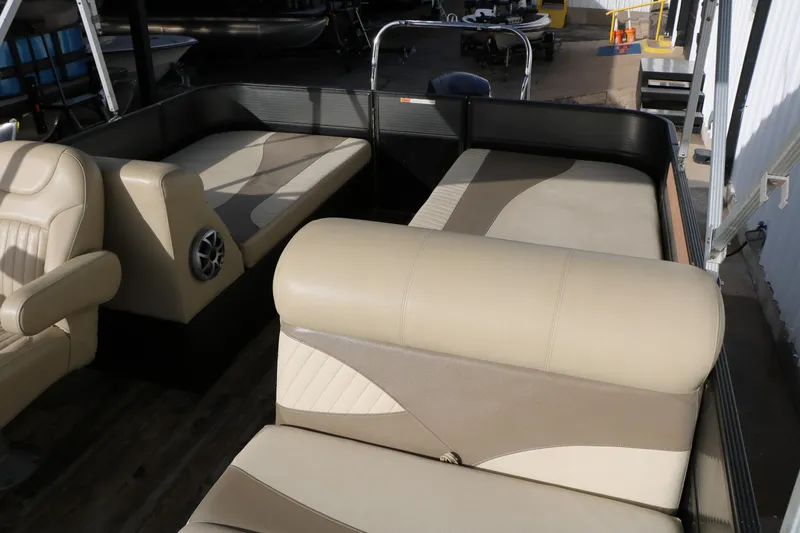 Slide: The Image of 2016 Crest II 250 pontoon boat interior with beige seating and speaker system. - 9