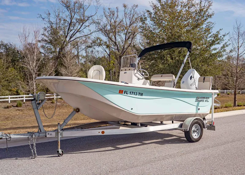 The Image of 2023 Carolina Skiff 17 LS boat on trailer, parked outdoors. - 1