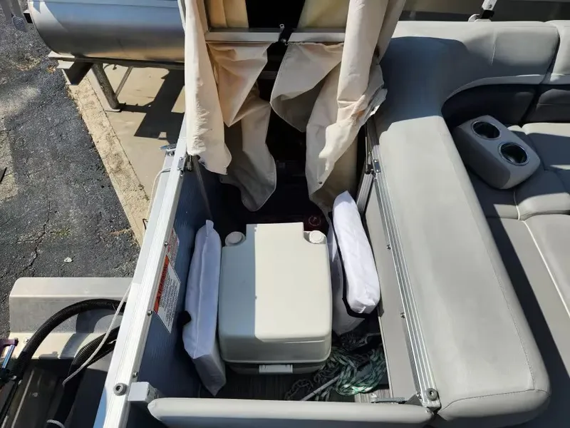 Slide: The Image of Interior of 2023 Bennington 22SXL with storage and seating area. - 10