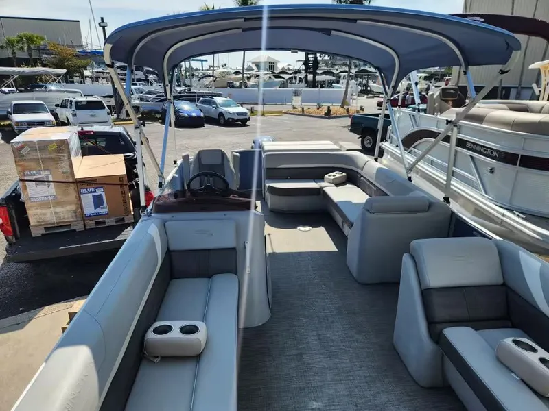 Slide: The Image of Interior view of a 2023 Bennington 22SXL pontoon boat at the marina. - 7