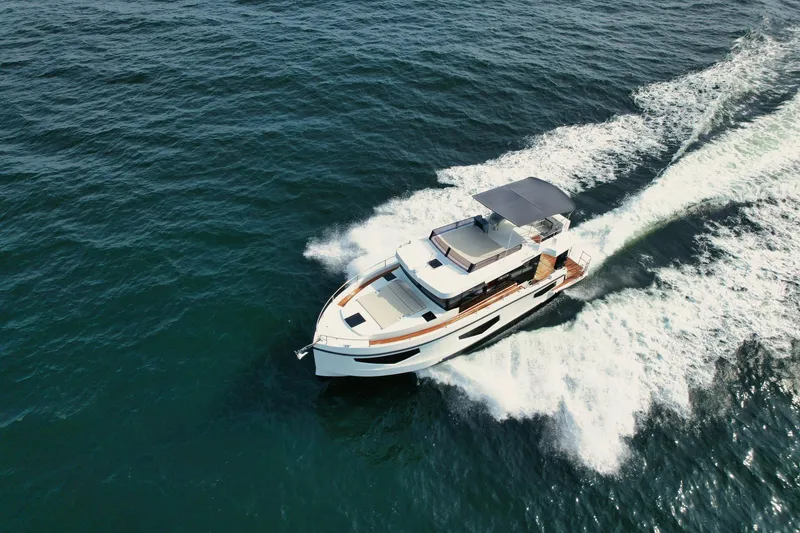 Slide: The Image of 2026 Cobra Yachts Seamaster 45 cruising on open water, aerial view. - 2