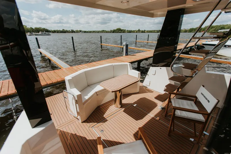 Slide: The Image of Luxurious 2026 Cobra Yachts Seamaster 45 deck with seating, table, and scenic water view. - 6