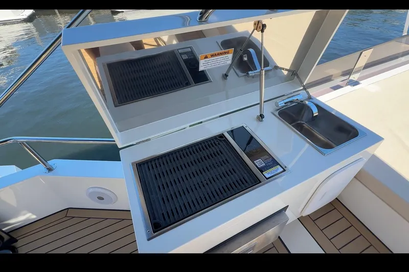 Slide: The Image of Outdoor kitchen on 2026 Cobra Yachts Seamaster 45, featuring grill and sink. - 9