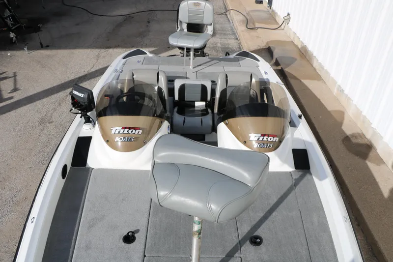 Slide: The Image of 2009 Triton 18 Explorer boat interior with seating and control panel. - 13