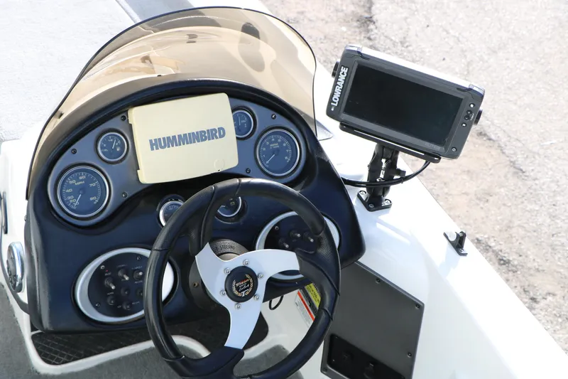 Slide: The Image of Dashboard of 2009 Triton 18 Explorer boat with Humminbird and Lowrance electronics. - 17