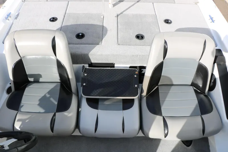 Slide: The Image of 2009 Triton 18 Explorer boat interior with dual gray and black seats. - 19