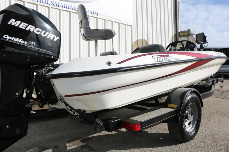Slide: The Image of 2009 Triton 18 Explorer boat with Mercury OptiMax engine on trailer. - 25