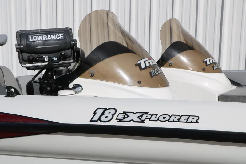 Slide: The Image of 2009 Triton 18 Explorer boat with Lowrance Elite fishfinder, featuring dual windshields. - 27