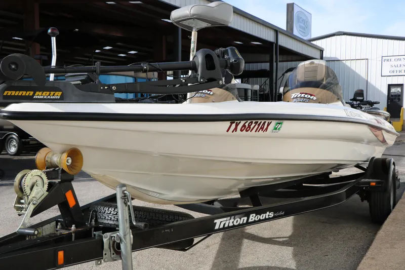 Slide: The Image of 2009 Triton 18 Explorer boat on trailer, featuring Minn Kota Maxxum motor. - 4