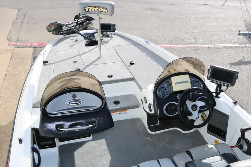 Slide: The Image of 2009 Triton 18 Explorer boat interior with steering console and electronics. - 9
