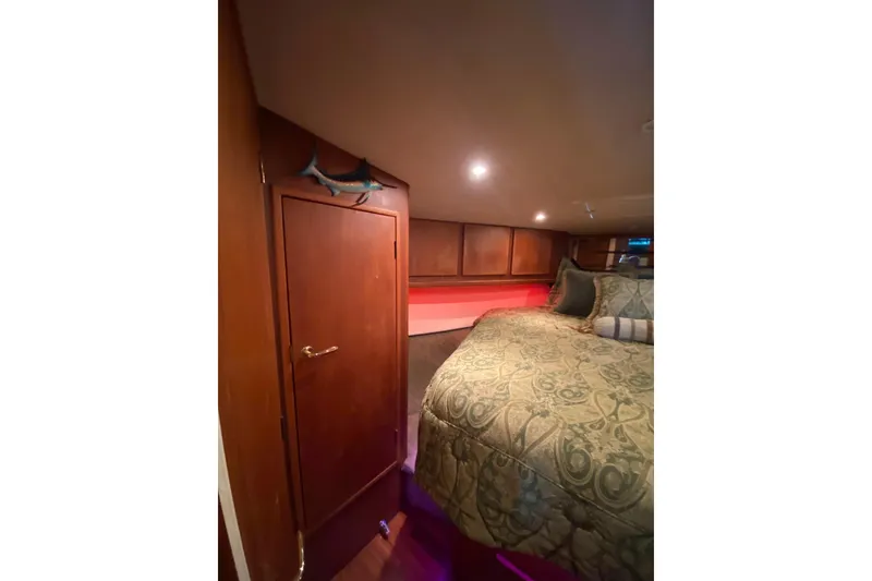 Slide: The Image of Luxurious cabin interior of 2001 Egg Harbor 37 Convertible yacht with elegant bedding. - 15