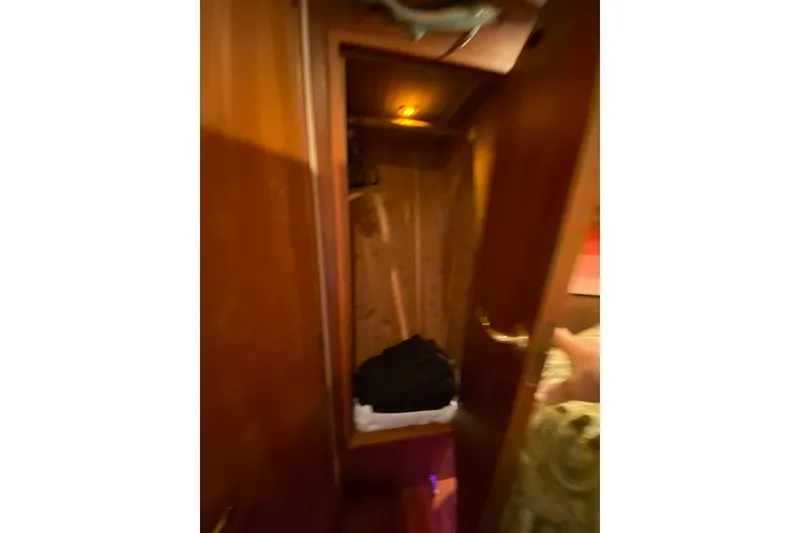 Slide: The Image of Interior view of a 2001 Egg Harbor 37 Convertible yacht closet with wooden finish. - 16