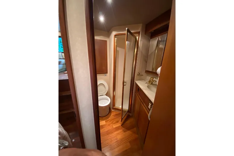 Slide: The Image of Luxurious bathroom in 2001 Egg Harbor 37 Convertible yacht with wood accents and modern fixtures. - 17