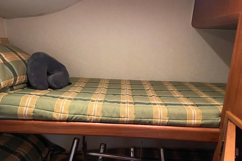 Slide: The Image of Bunk bed with plaid bedding in 2001 Egg Harbor 37 Convertible yacht cabin. - 19