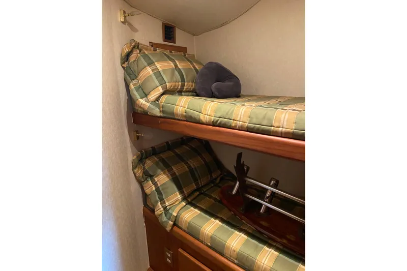 Slide: The Image of Bunk beds with plaid bedding in 2001 Egg Harbor 37 Convertible yacht cabin. - 20