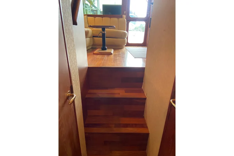 Slide: The Image of Interior view of 2001 Egg Harbor 37 Convertible yacht with wooden stairs and seating area. - 22