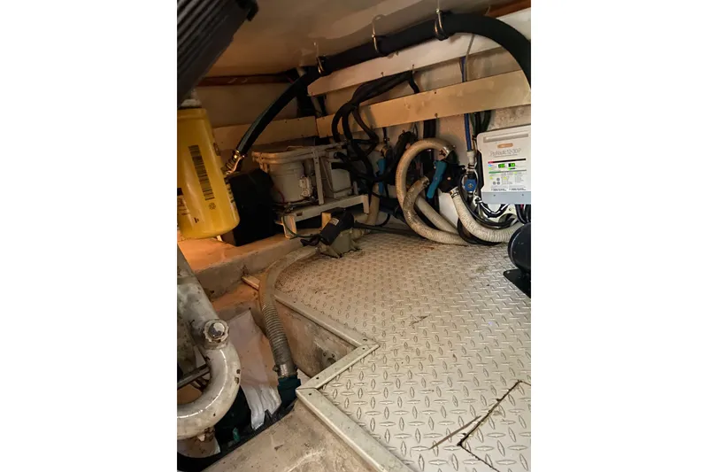 Slide: The Image of Engine room of 2001 Egg Harbor 37 Convertible with mechanical components and wiring. - 35