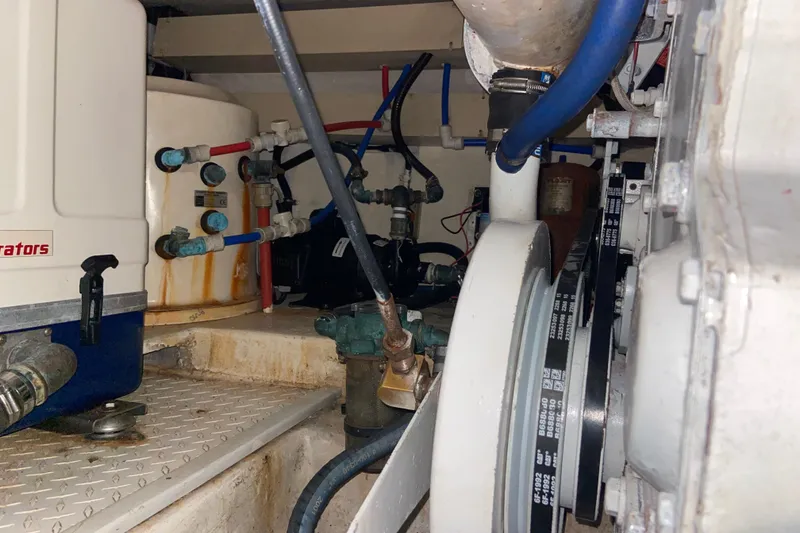 Slide: The Image of Engine room of 2001 Egg Harbor 37 Convertible with visible machinery and piping. - 37