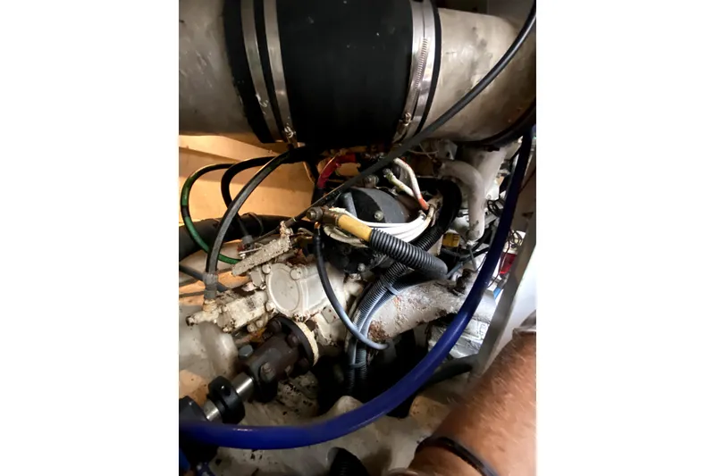 Slide: The Image of Engine components of a 2001 Egg Harbor 37 Convertible boat, featuring various hoses and connections. - 39